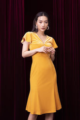 Velvet midi dress with flutter sleeves, pearl button detail, and figure-enhancing silhouette